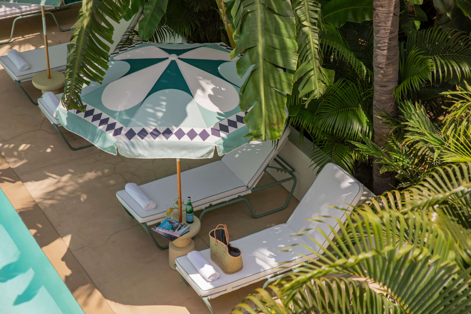 Poolside comfort with thick, soft cushions and chic parasols.