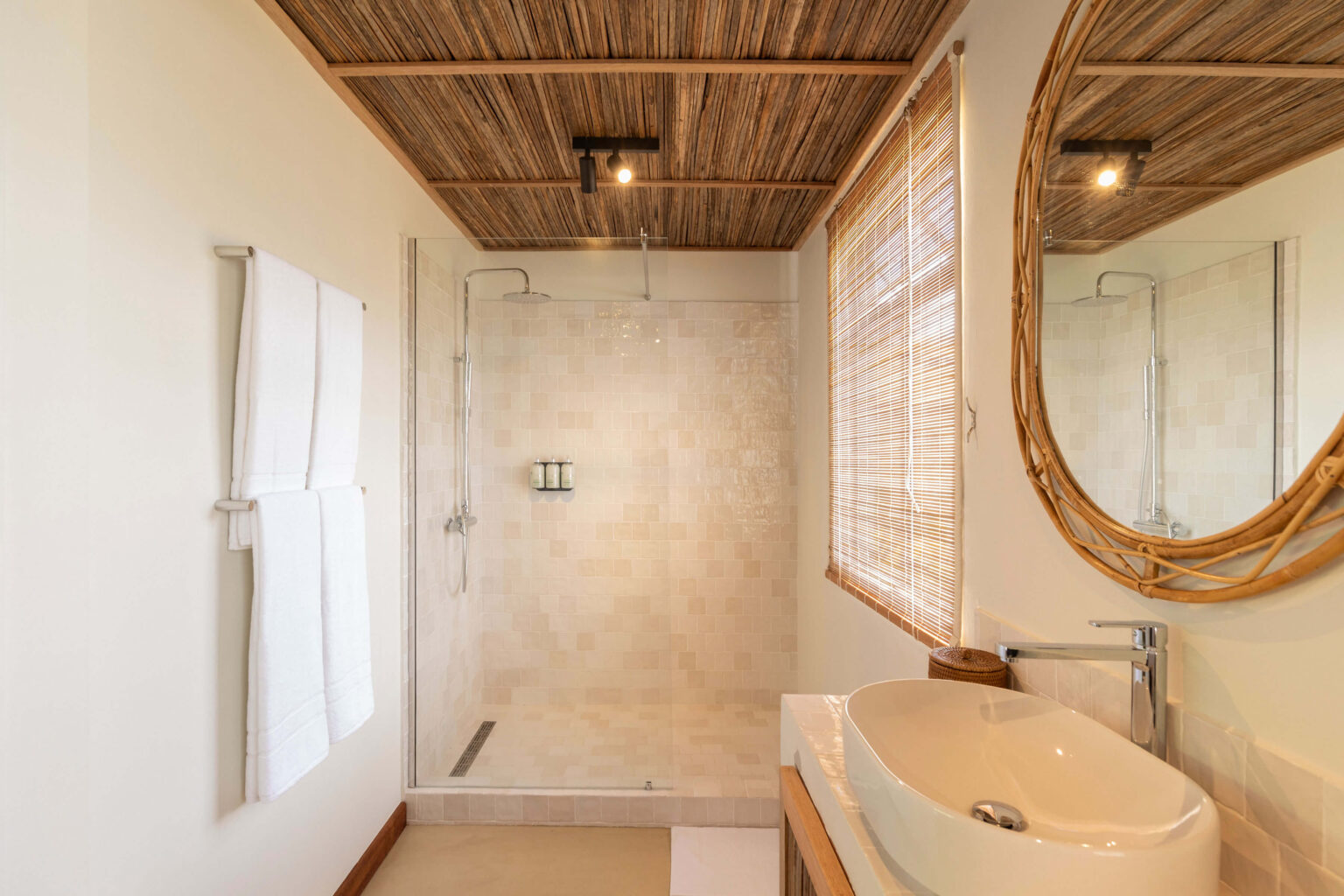 A spacious deluxe suite bathroom with a walk-in shower 