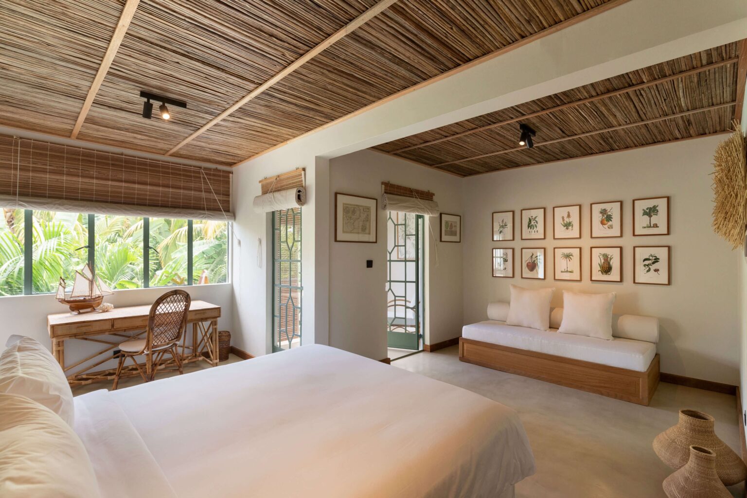  Deluxe suite bedroom, generous in size, with a daybed and desk.